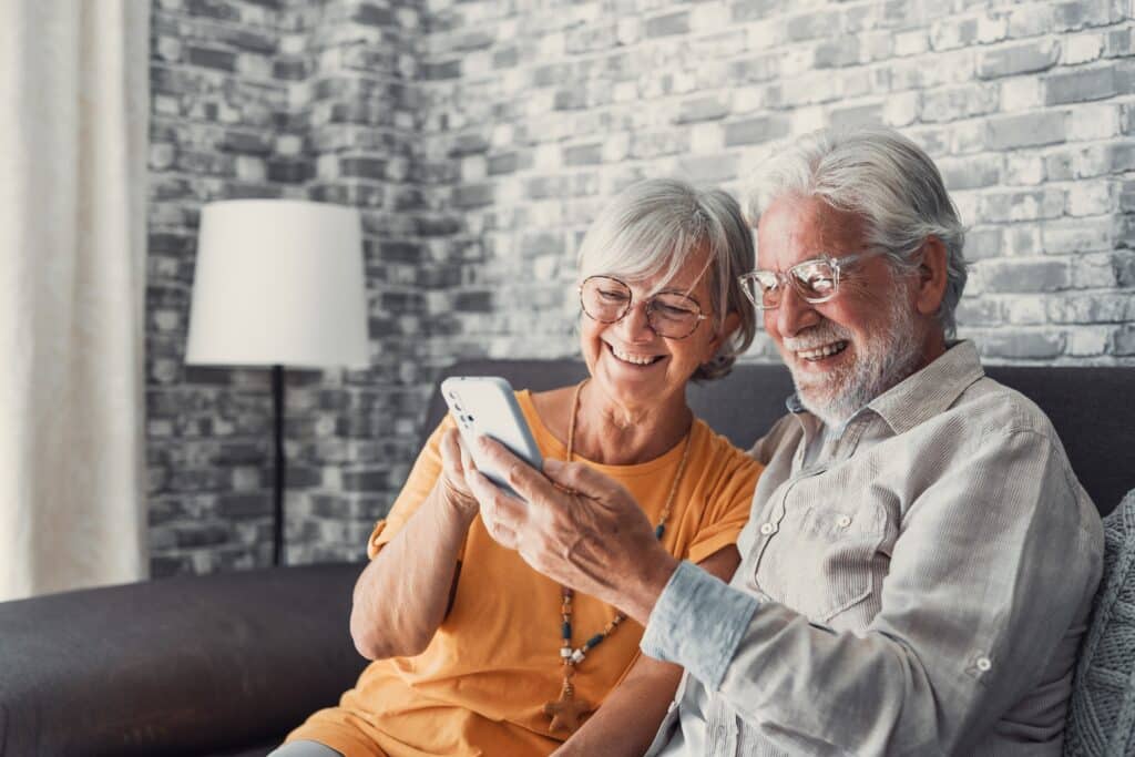 Elderly,Grandfather,And,Grandmother,Spend,Time,Having,Fun,Using,Smartphone