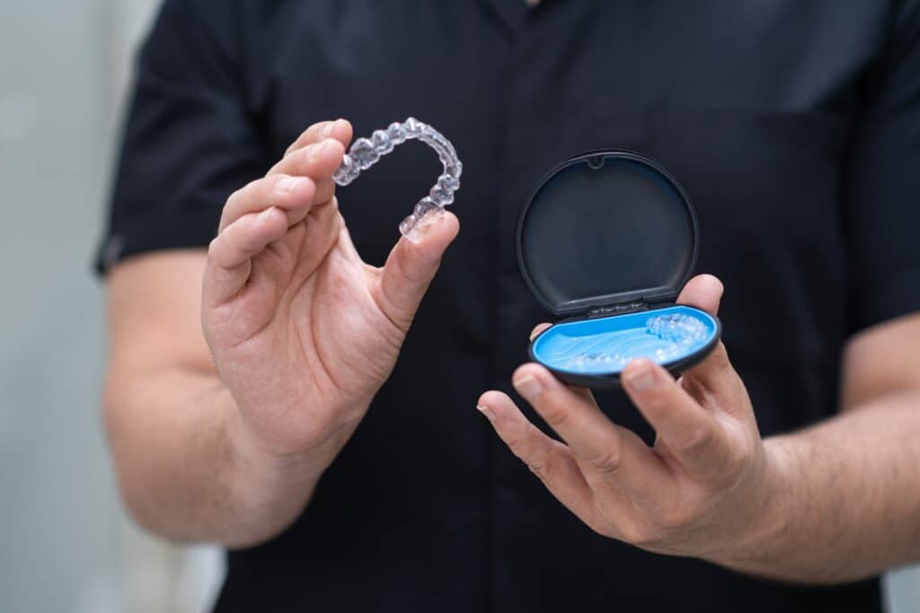 Orthodontist,Taking,Out,Clear,Aligners,For,Teeth,Correction,Of,Open