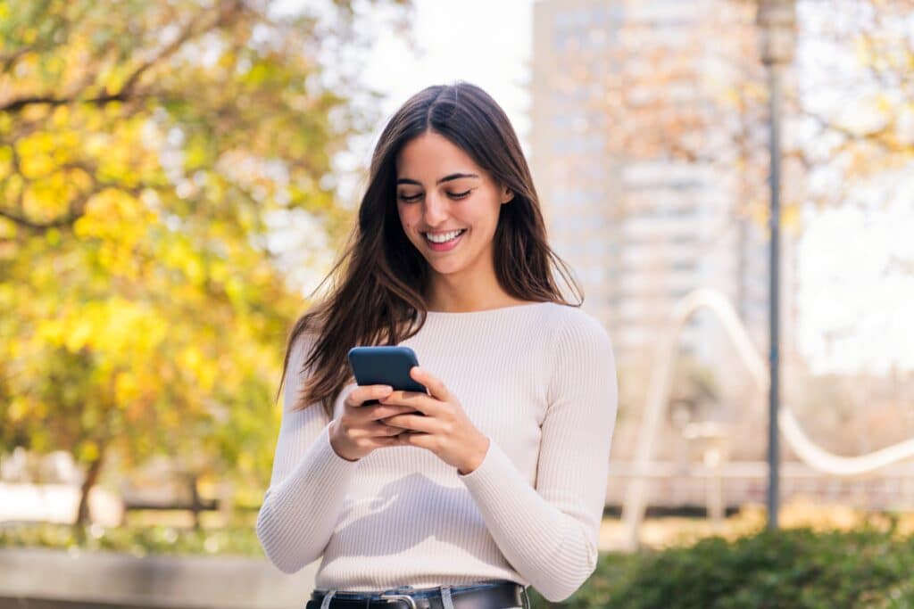 Caucasian,Woman,Smiling,Happy,Using,Her,Mobile,Phone,,Concept,Of